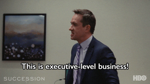 A gif from HBO show Succession showing a white man angrily throwing a water bottle and yelling "This is executive-level business!"