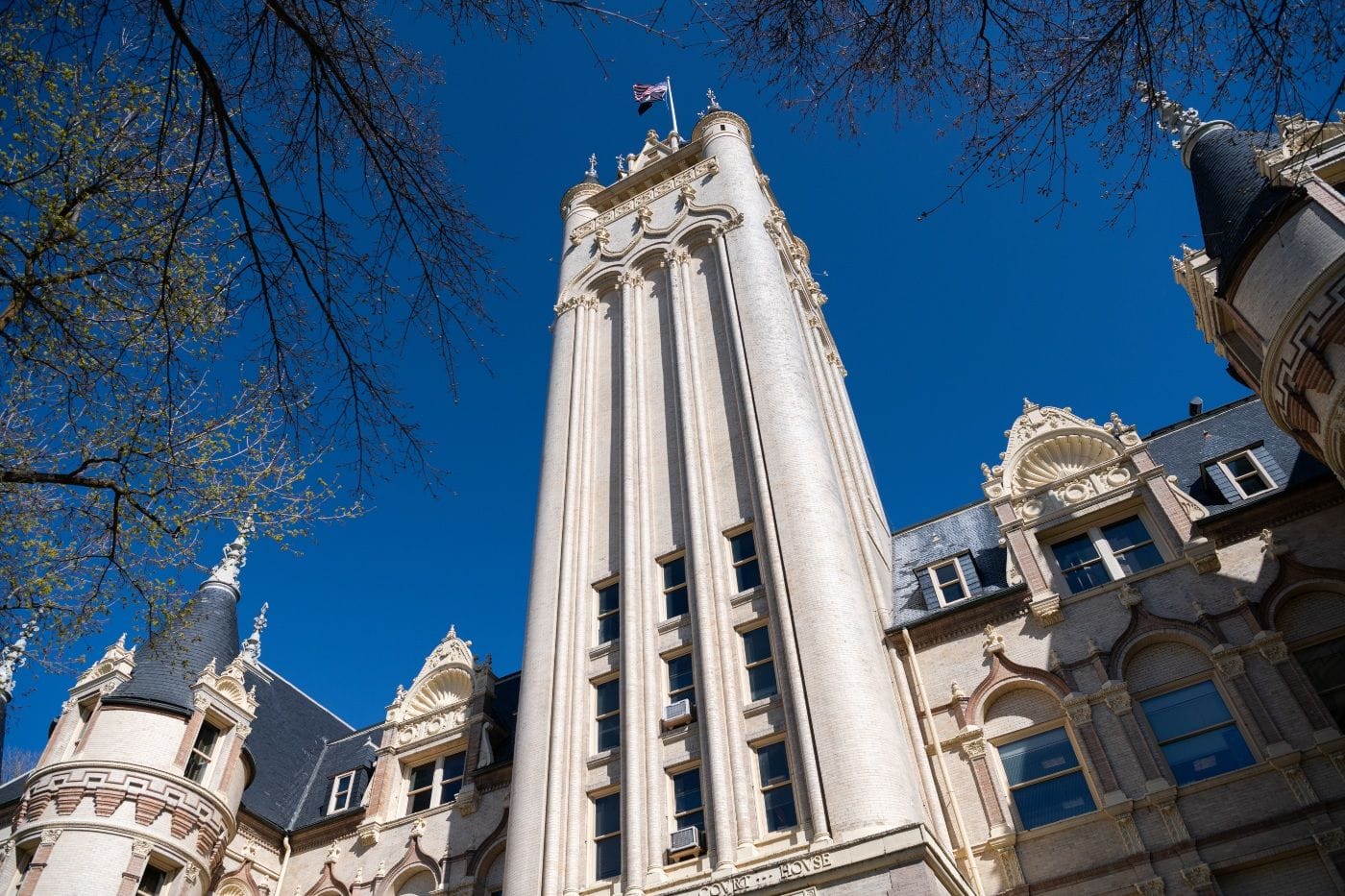 A view of the Spokane County Courthouse, a white castle-looking building, from the ground.