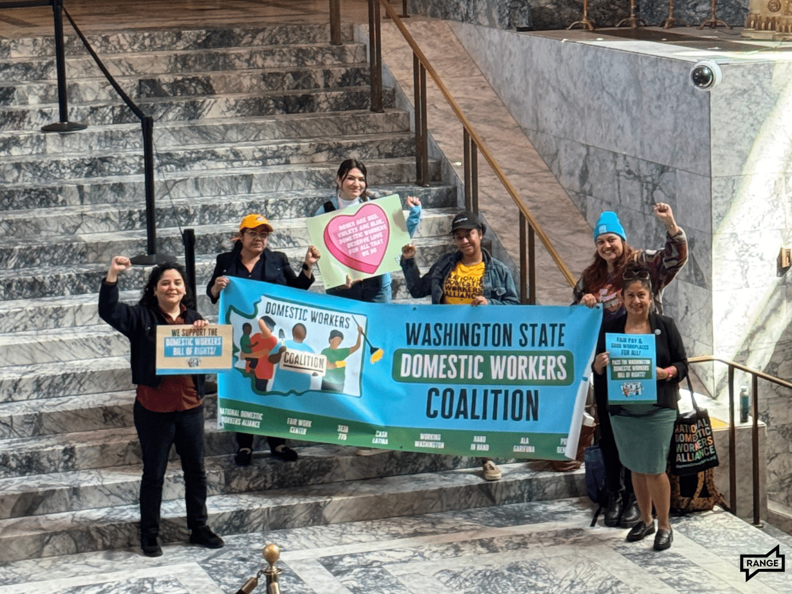 Domestic laborers pose inside the capitol building. 